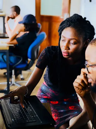 Students work together over a computer.