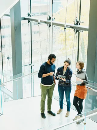 Drexel students talking in an atrium