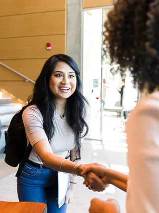 Business student introducing herself to a professor