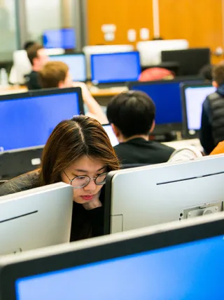 Drexel economics student in the business trading lab