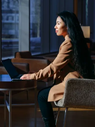 Business Student works on laptop in lobby