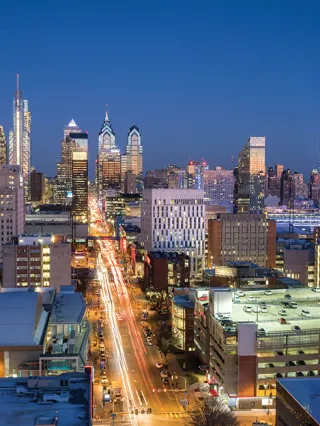 Philadelphia skyline at night with a view of Drexel's campus
