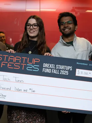 The Close School of Entrepreneurship presents Startup Fest 2025 winners with a check for $10,000.